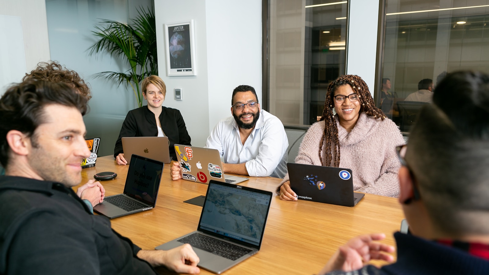 42 technology team four people all on laptops two men and two women listen to ZT5v0puBjZI